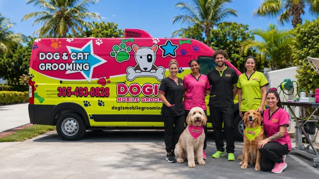 Dogi's grooming team standing with two dogs in front of the mobile grooming van